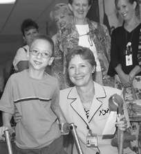 Young patient Cody Mitchell stops for a photo with physical therapist Jan Simpson at the East Tennessee Children's Hospital Rehabilitation Center, a United Way agency, during an ORNL United Way team visit.