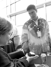 Metals and Ceramics Division researcher James Klett demonstrates the heat-conducting properties of carbon foam to a CASW participant who is melting ice placed on the foam with the heat of her hands.