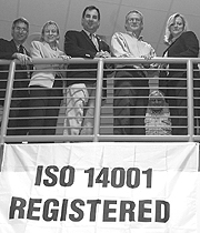 (From left) Jeff Smith, Kathy Carney, Oak Ridge Mayor David Bradshaw, David Skipper and Karen Downer pose with the ISO 14001 banner on Main Street.
