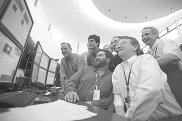 The SNS control room goes from anticipation to jubilation at the sight of first neutrons. From left, John Haines, Thom Mason, Erik Iverson, Tony Gabriel, Les Price, David Freeman and Ian Anderson.
