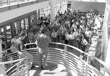 Jeff Wadsworth (stairwell, left) and Thom Mason address SNS staff at the first neutrons victory celebration.