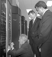 Sen. Bob Corker adds his name to the, by now, long list of VIPs who have signed ORNL's supercomputer, with hosts Jeff Wadsworth (center) and Thomas Zacharia.