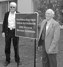 Former ORELA directors Fred Maienschein (left) and Jack Harvey flank the new sign with the nuclear historic landmark designation.