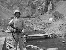 Eric Mulkey stands near a bridge construction site in Salang Valley, Afghanistan, during an inspection of the project in October 2006.