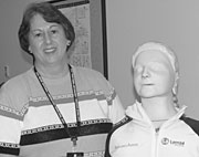 Stephanie Burke and her Red Cross training partner, a CPR demonstration mannequin.