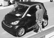 vehicle show. Wendell Sharp (bottom) ponders a Mercedes-Benz Smart Fortwo.