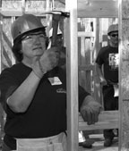 Michelle Buchanan pounds a nail for Habitat for Humanity.